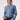 Brunnette woman wearing a blue tencel button down shirt on a white background.