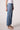 Blue Revival Beau button down jeans in Ora, side view showing the mid-rise straight-leg silhouette and gold button detailing.
