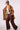 Woman wearing the Blue Revival Cassie trench coat in latte showing the plaid lining as an elevated everyday outerwear look.