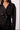 Close-up of the Blue Revival Charli cropped trench coat in black showing the oversized buttons, lapels and soft scuba fabric.