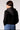 Blue Revival Fireside cropped blazer in black with removable puffer hoodie insert, back view showing the cropped silhouette and star-print puffer insert.
