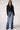Woman wearing the Blue Revival Fireside cropped black blazer with removable puffer hoodie insert and double-breasted front.