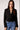 Blue Revival Fireside cropped black blazer without the removable puffer hoodie insert, featuring a double-breasted front and classic flap pockets.