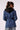Blue Revival Gracie trench coat in medium stone, side view showing the fitted silhouette, belted waist and removable black hoodie insert.