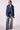 Woman wearing the Blue Revival Gracie trench coat in medium stone with the Blue Revival Waverly wide leg jeans in Dallas.