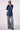 Woman wearing the Blue Revival Gracie trench coat in medium stone with a removable black hoodie insert and belted waist.