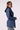 Blue Revival Gracie trench coat in medium stone, side view showing the fitted silhouette, belted waist and removable black hoodie insert.