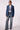 Blue Revival Gracie trench coat in medium stone without the removable black hoodie insert, showing the double-breasted front and tie belt.