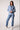 Woman wearing the Blue Revival Helen blazer in heather blue with removable denim insert and a fitted silhouette.