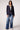 Woman wearing the Blue Revival Helen double breasted navy blazer with removable grey hoodie insert and fitted silhouette.