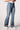 Blue Revival Maya mid-rise bootcut jeans in Medium Tel Aviv, side view showing the mid-rise waist and fitted silhouette through the hip.