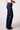 Blue Revival Maya mid-rise recycled bootcut jeans in Amsterdam dark wash, side view showing the fitted silhouette and bootcut leg.