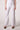 Blue Revival Palazzo pants in white with a mid-rise fit and flowing wide-leg silhouette.
