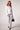 Blue Revival Palazzo Pant in white styled with a peplum jacket for a polished, contemporary look.