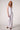 Woman wearing the Blue Revival Palazzo pants in white with a polished wide-leg silhouette.