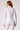 Blue Revival Piper peplum jacket in white, back view showing the fitted waist and peplum shape.