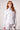 Blue Revival Piper peplum jacket in white with sculpted waist-cinching fit and silver buttons.