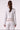 Blue Revival Sadie denim jacket in white, back view showing the clean denim silhouette and tan faux suede detailing.