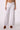 Blue Revival Sadie mid rise wide leg jeans in white with tan faux suede pocket detailing.
