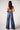 Blue Revival Selena mid-rise recycled wide-leg jeans in Prague, back view showing the relaxed wide-leg fit.