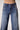 Close-up of Blue Revival Selena recycled wide-leg jeans in Prague showing the front pockets, buttons and stretch denim.