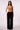 Woman wearing Blue Revival Taylor low-rise wide-leg trousers in black with a tailored, office-ready look.