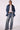 Woman wearing Blue Revival Waverly mid-rise wide leg jeans in Dallas wash styled with the Gracie trench coat.